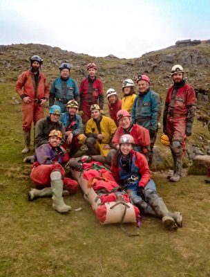 The team, with the casualty still in the stretcher, after successfully bringing her to the surface